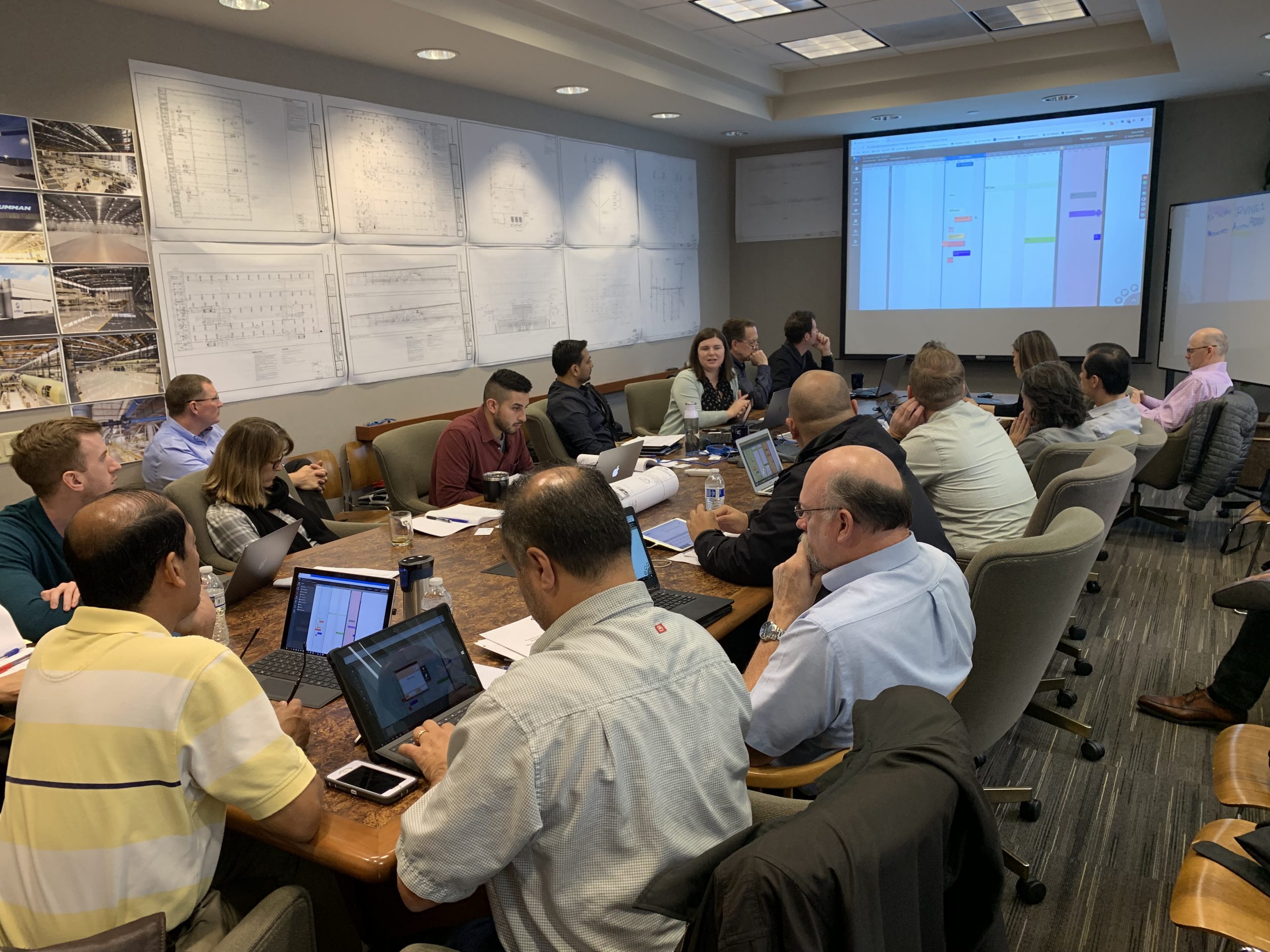Team of engineers review plans on screen|screenshot of pull-planning software known as Touchplan